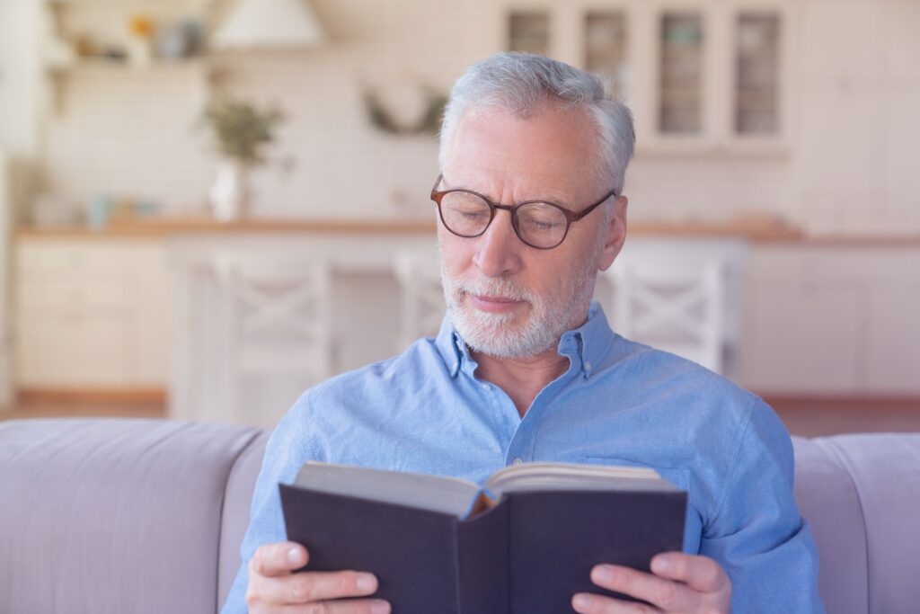 Senior man enjoying a book at home